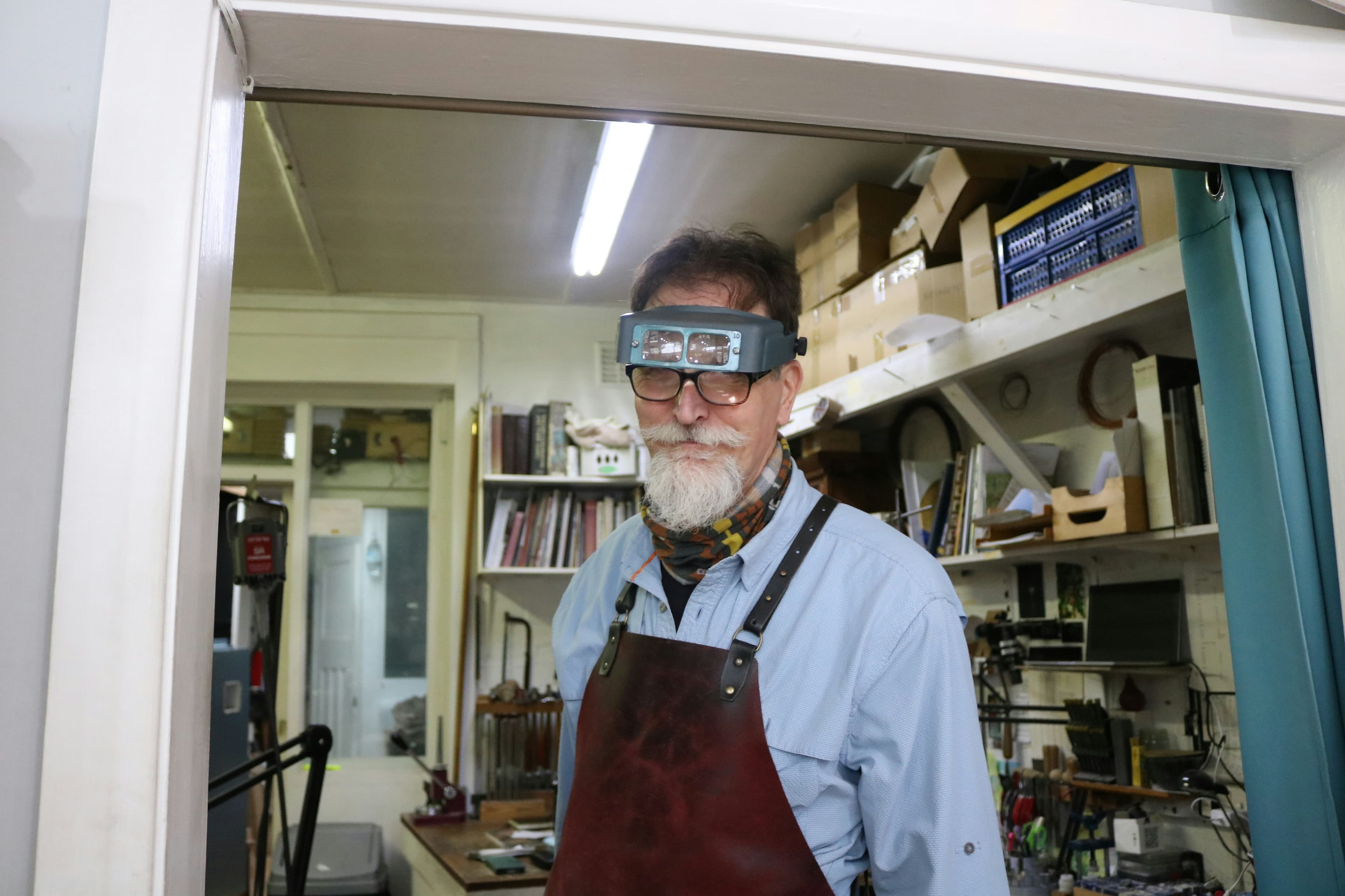 Juwelier mit Lupe in der Werkstatt